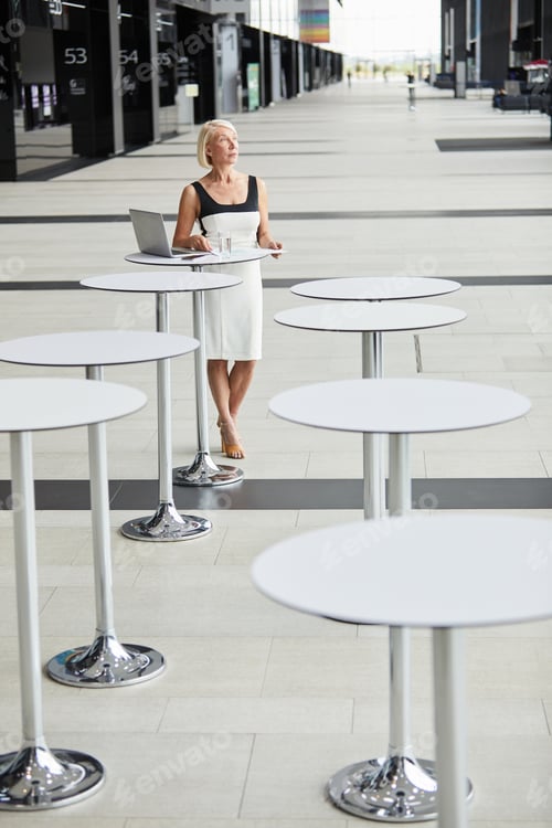 Preview: Woman in cafe at business building