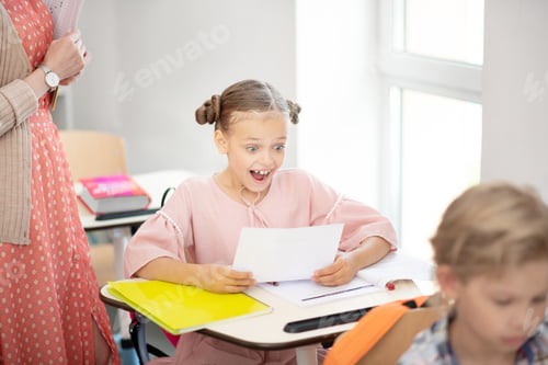 Preview: Excited Girl Receives Good Grades in Classroom