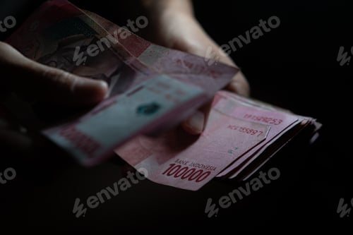 Preview: holding money in dark room