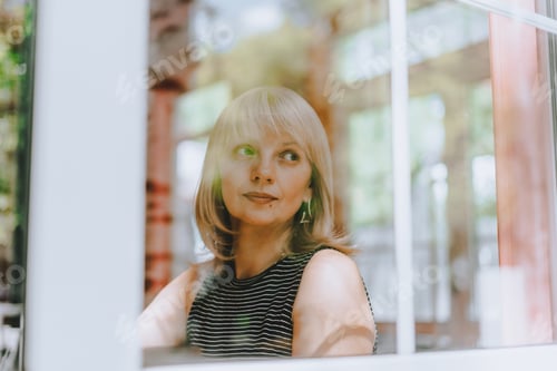 Preview: Senior Woman sits in front of the window. Looking sad and thoughtful. Mental health and depression