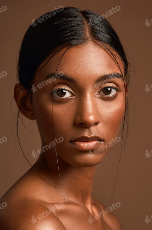 Preview: Portrait of a beautiful young woman posing against a brown background