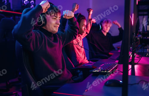 Preview: Celebrating victory. Gamers are playing video game by computers