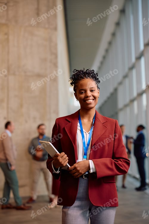 Preview: Happy black businesswoman hosting a business seminar and looking at camera.