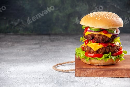 Preview: Delicious homemade sandwich on wooden board tied up with rope on the left side on blurred background