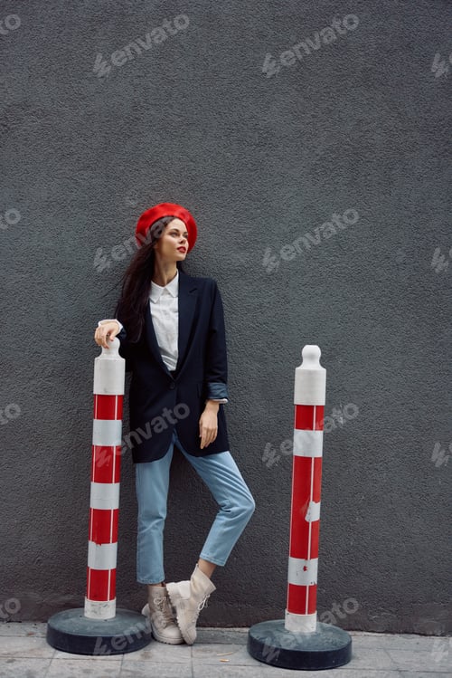 Preview: Fashion woman standing on the street in front of the city and road works tourist in stylish clothes