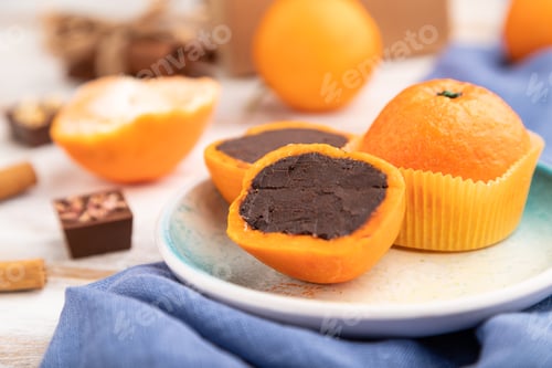 Preview: Truffle chocolate tangerine candies on a white wooden background. Side view, selective focus.