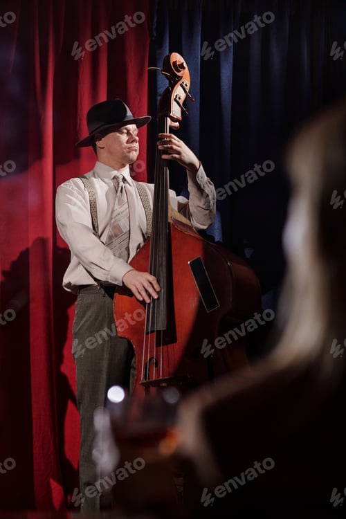 Preview: Middle Aged Caucasian Man Playing Double Bass on Stage during Jazz Performance
