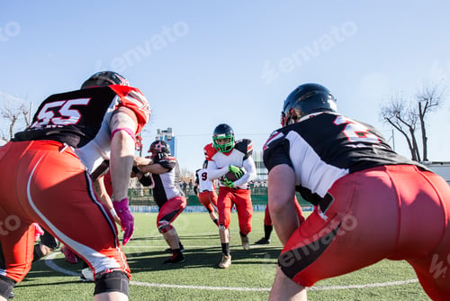 Preview: American football player running with the ball during a match