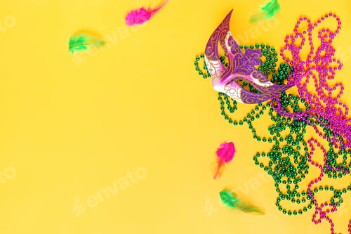Preview: Mardi gras accessories flat lay on bright yellow background