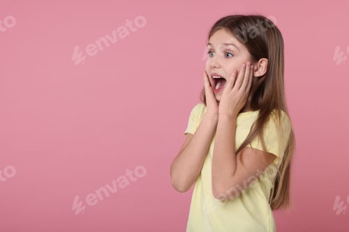 Preview: Portrait of surprised girl on pink background. Space for text