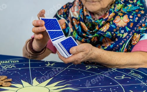 Preview: Fortune teller reads tarot cards. selective focus.
