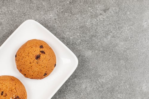 Preview: Two chocolate cookies on white plate
