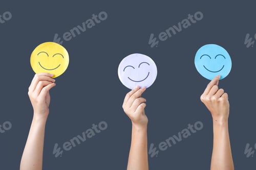 Preview: People Holding Smile or Happy Emoticons in Hands Against Gray Background