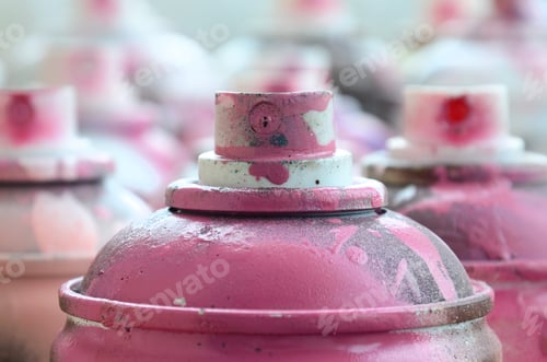 Preview: A lot of dirty and used aerosol cans of bright pink paint. Macro photograph with shallow