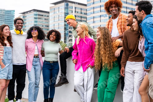 Preview: Happy playful multiethnic group of young friends bonding outdoors