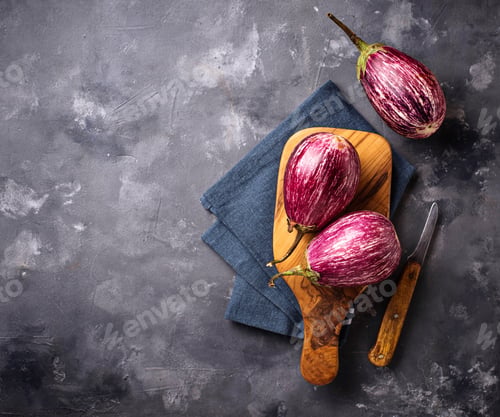 Preview: Fresh striped purple aubergines on grey background