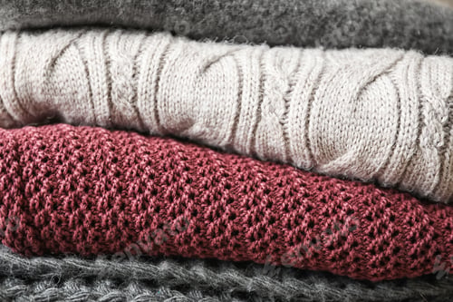 Preview: Stack of warm knitted clothes as background