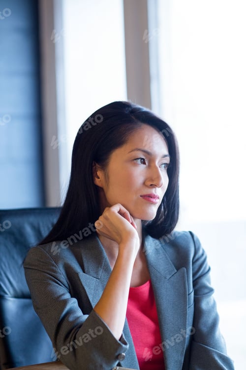 Preview: Businesswoman sitting in leather office chair near bright window with soft natural light