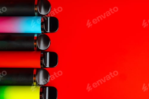 Preview: Colorful disposable electronic cigarettes on red background