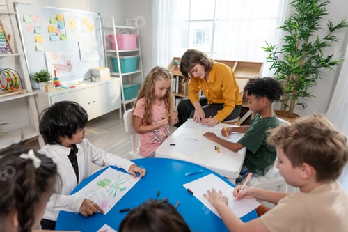 Preview: Caucasian beautiful young woman teacher teaching art to kids at nursery.