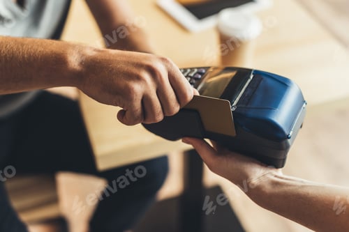 Preview: partial view of man paying for order with credit card in cafe