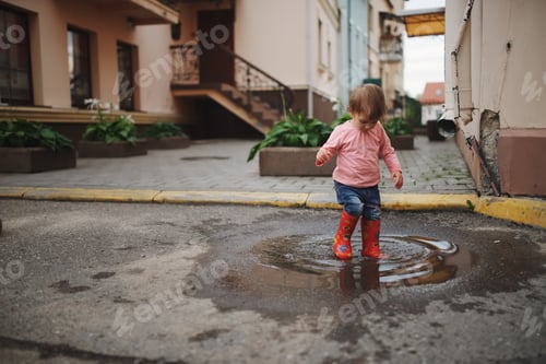 Preview: girl plays in the puddle outdoors