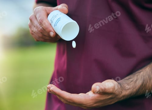 Preview: Pill box, medicine and man hand closeup of a sport on a soccer field with tablet and drugs for heal