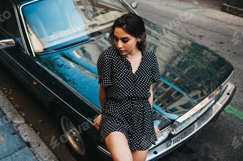 Preview: Sensual woman sitting on car