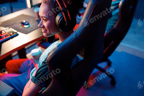 Preview: Female gamer relaxing during tournament in cyber club