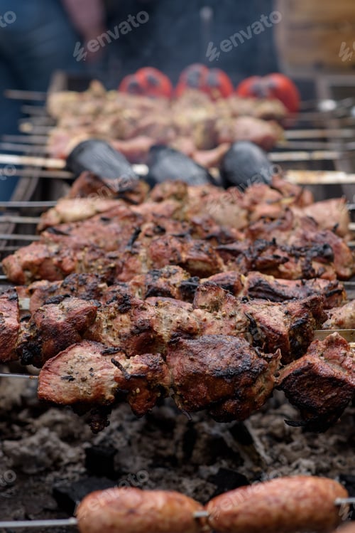 Preview: Grilled skewers of meat on the coals, with smoke. street food.