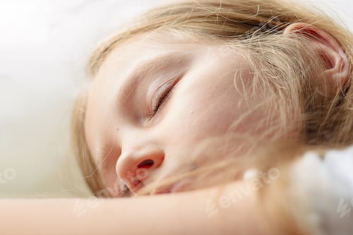 Preview: Calm blond child girl sleeps on white soft pillow bed Kid closed eyes portrait close-up Sleeping app