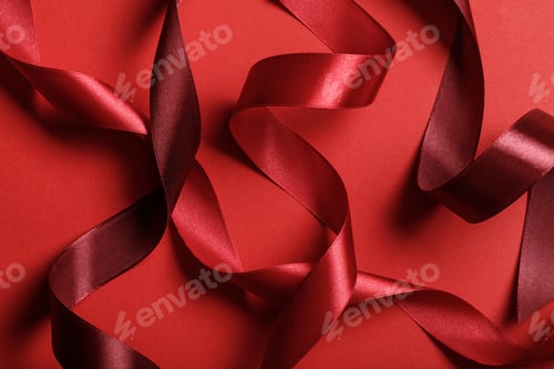 Preview: close up of silk burgundy and red ribbons on red background
