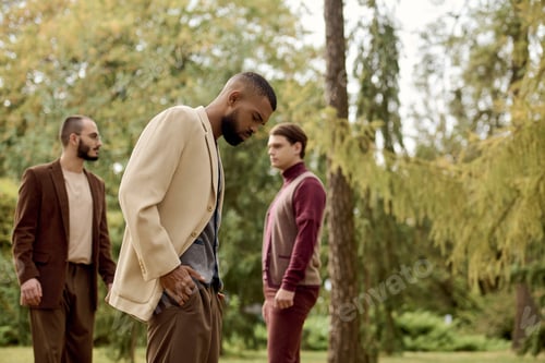 Preview: Handsome men showcasing stylish autumn fashion in a vibrant field of golden leaves
