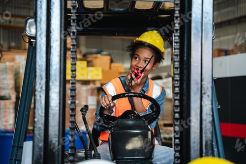Preview: Portrait of a female worker with a forklift in the warehouse., Industrial and industrial concept.