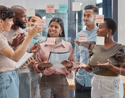 Preview: Shot of a group of young businesspeople having a discussion at the office