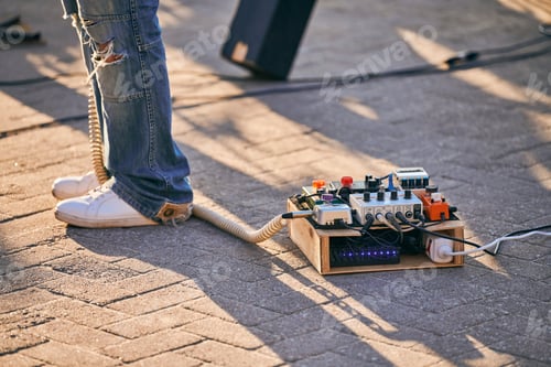 Preview: Effects pedal box for electric guitar on floor at outdoor rock party, guitar effects unit