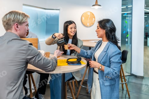 Preview: Coworkers pouring coffee during office break in coworking space