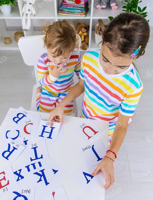 Preview: The child learns English letters. Selective focus.