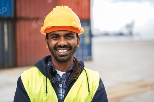 Preview: Happy Indian man smiling on camera with industrial port on background - Focus on face