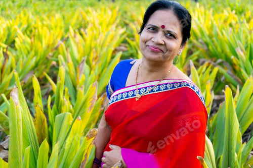 Preview: Happy Indian woman in the turmeric field