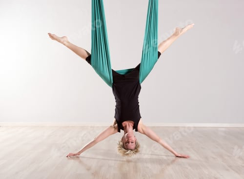 Preview: Single upside down woman doing aerial yoga splits