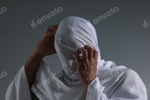 Preview: Creepy ghost. Man covered with white sheet on light grey background