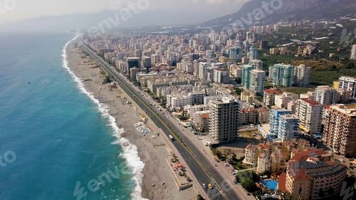 Preview: Top view of beautiful big city by sea on background of mountains. Clip. Panorama of southern resort