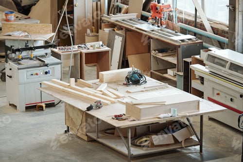 Preview: Workbench of furniture factory worker with wooden workpieces, electric handtools