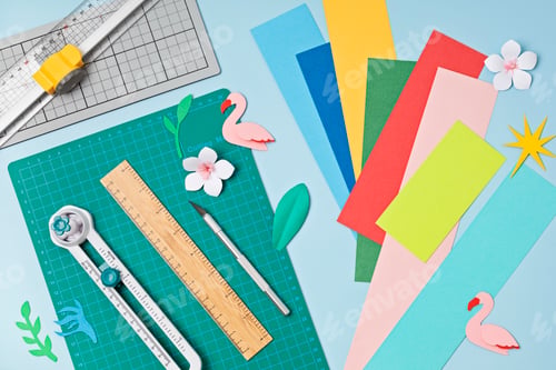 Preview: Top view over paper cut tools, scissors, cutter, cutting mat and paper