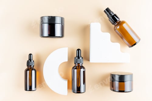 Preview: Trendy presentation of cosmetic set for skin care. Top view of dark glass packaging - dropper bottle