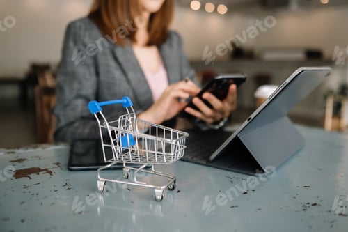 Preview: Woman using smart phone for mobile payments online shopping
