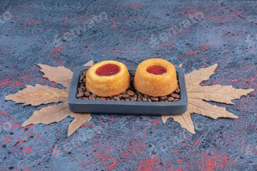 Preview: Jelly cakes and coffee beans in a small tray on abstract background