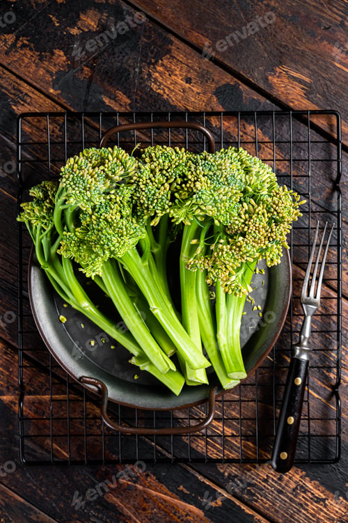 Preview: Fresh Raw Organic Broccolini cabbage in a steel tray. Wooden background. Top view