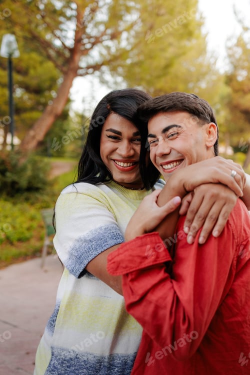 Preview: Latin transgender woman and man embracing in park